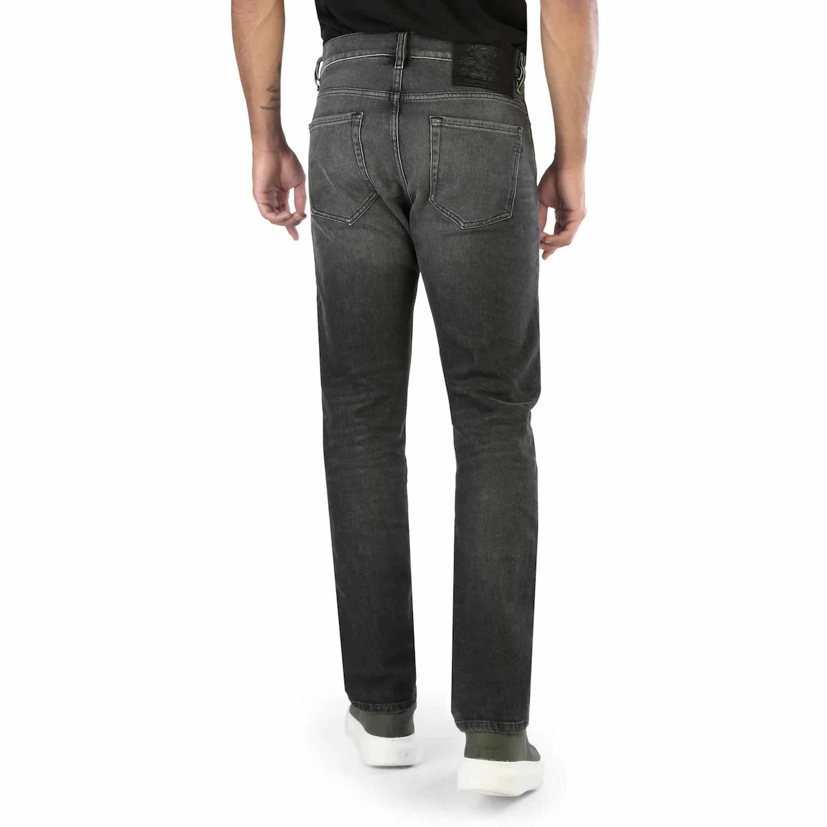 Person wearing black jeans on a white background